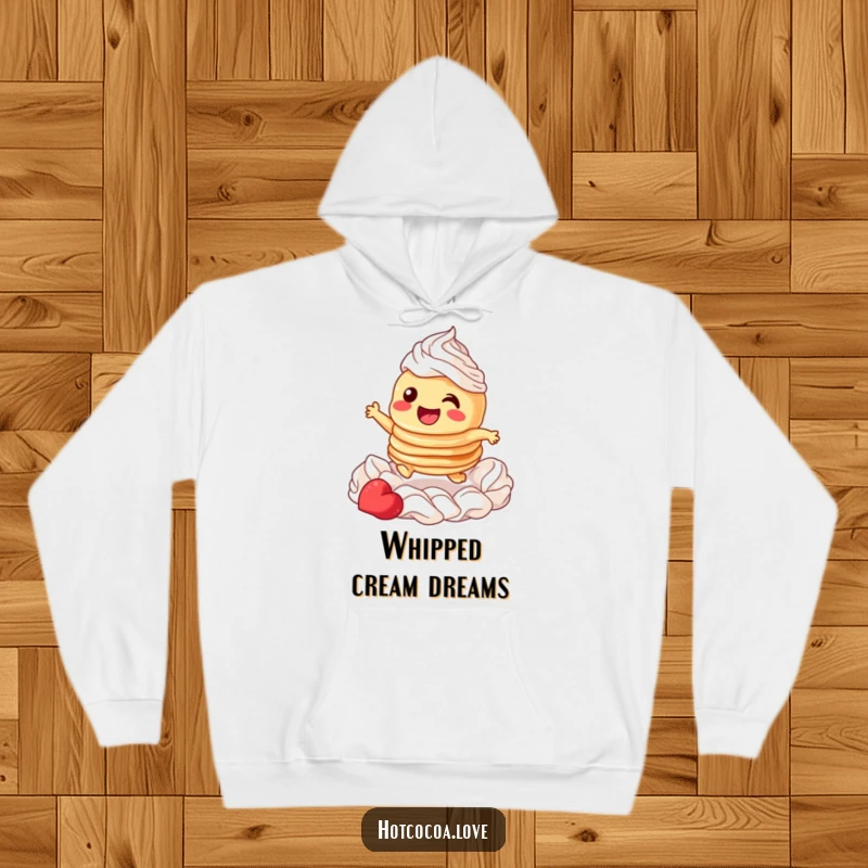 Funny hoodie showcasing a giggling stack of pancakes character joyfully leaping through fluffy whipped cream, perfect for cozy mornings.